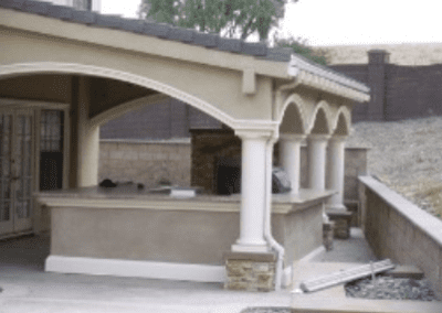 A home with a covered patio and a fireplace.
