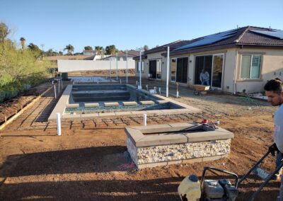 A man is working on the construction of a swimming pool.