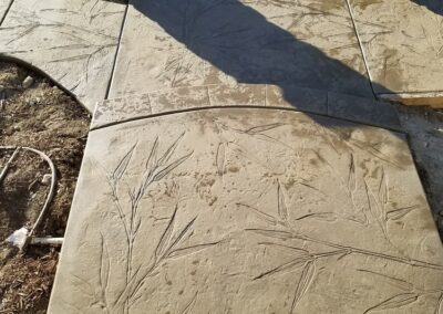 A concrete walkway with a design on it.